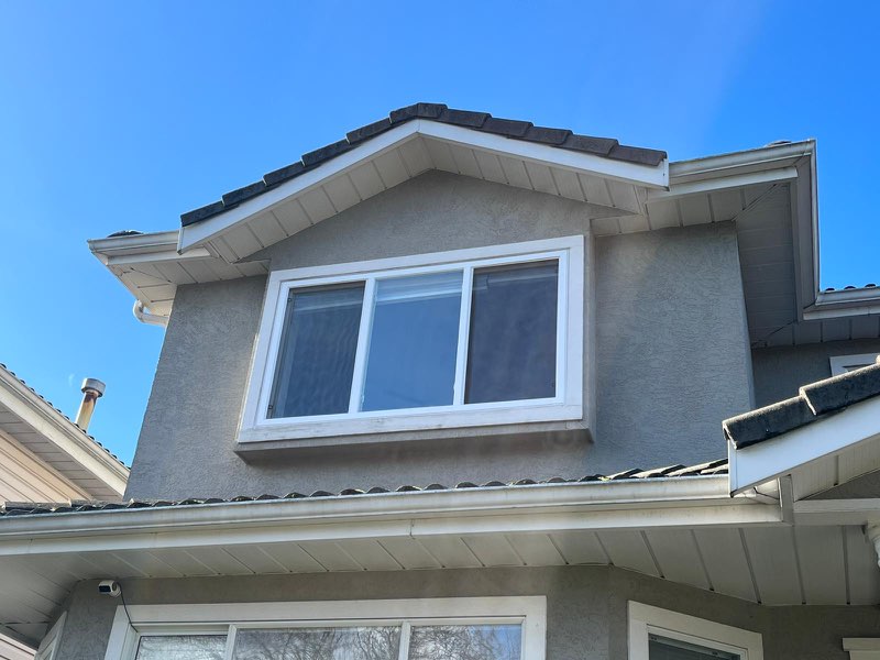 Residential second-floor window upgrade with clean white framing in Burnaby