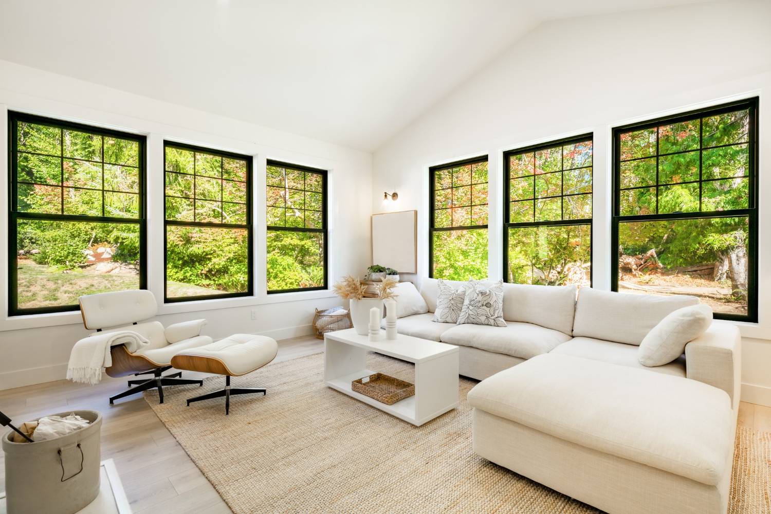 Port Moody contemporary living room transformed with custom oversized black windows for maximum sunlight