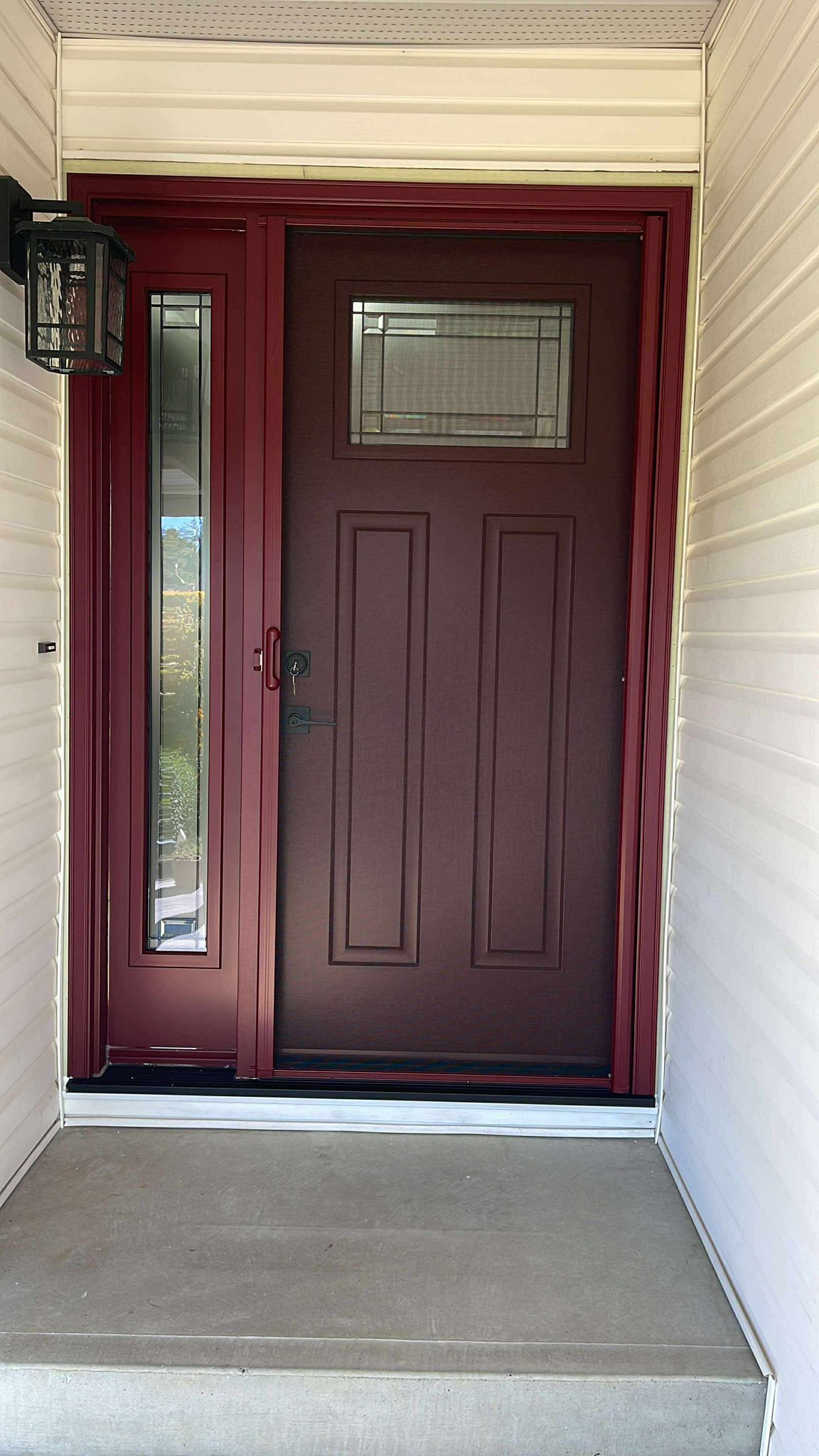 North Vancouver home entry with burgundy door and retractable screen