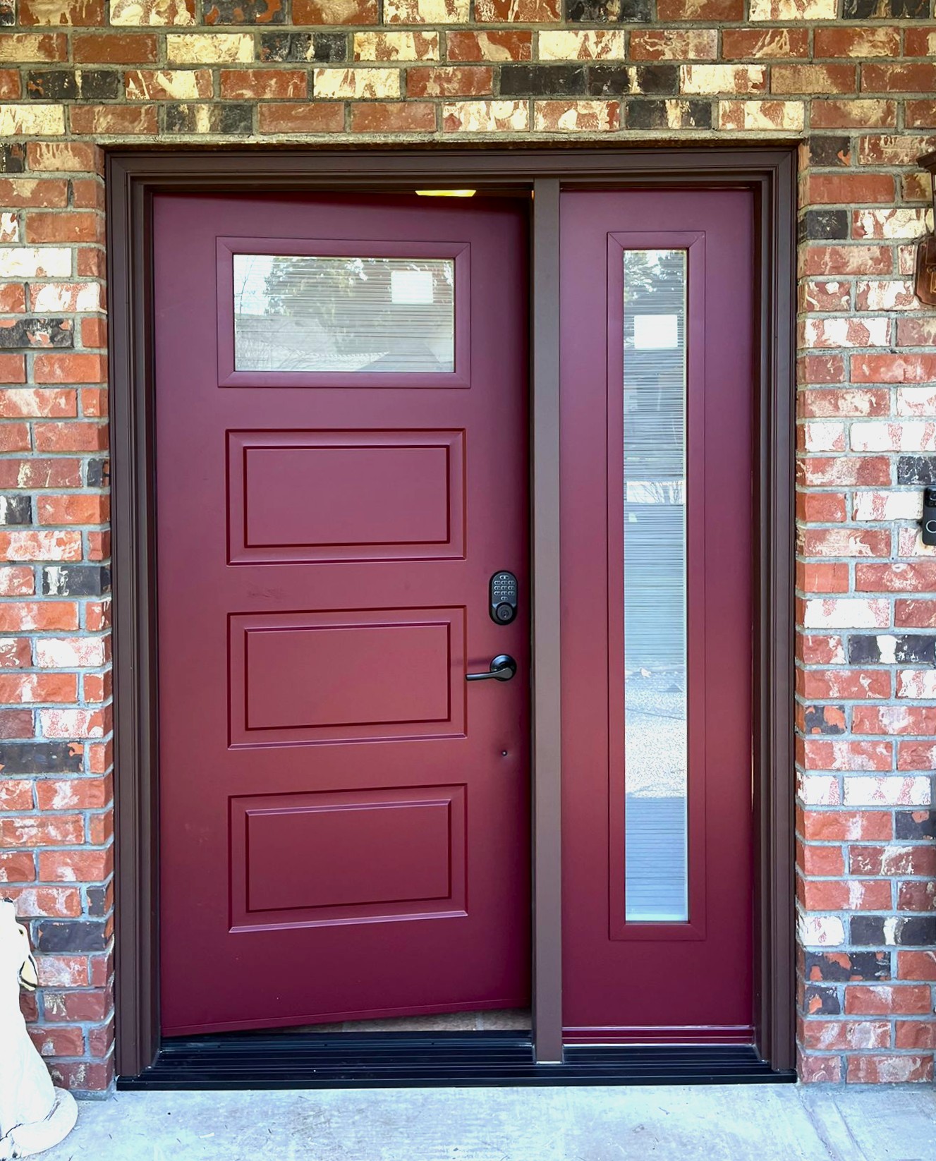 Custom steel entry door with burgundy color and sidelight for natural light in Port Moody, BC