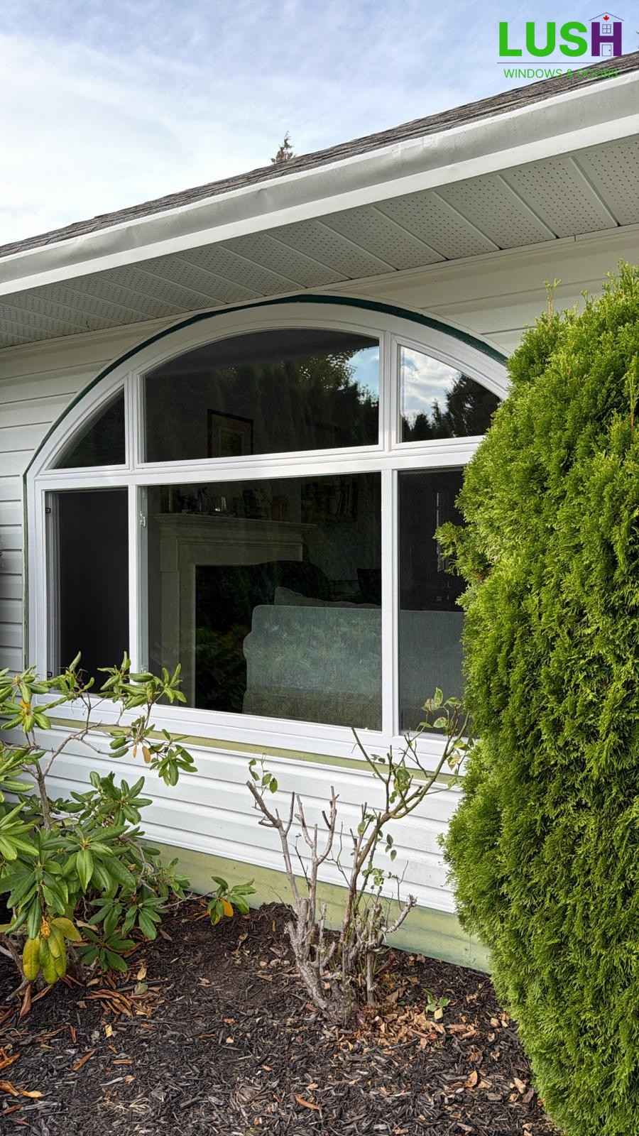 White arched window installation enhancing natural light in residential home