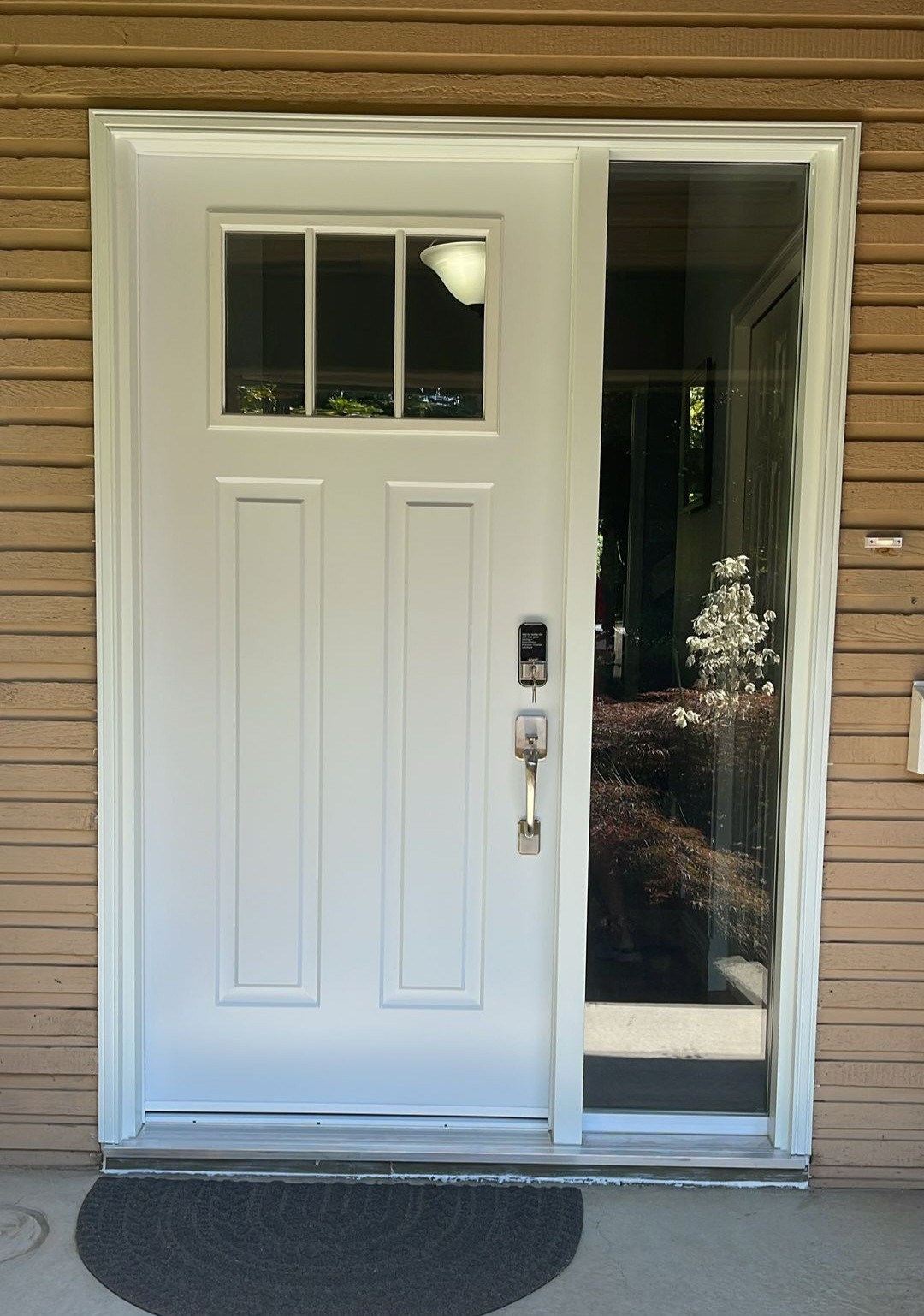 White exterior door accented by clear sidelight for natural light in Whiterock