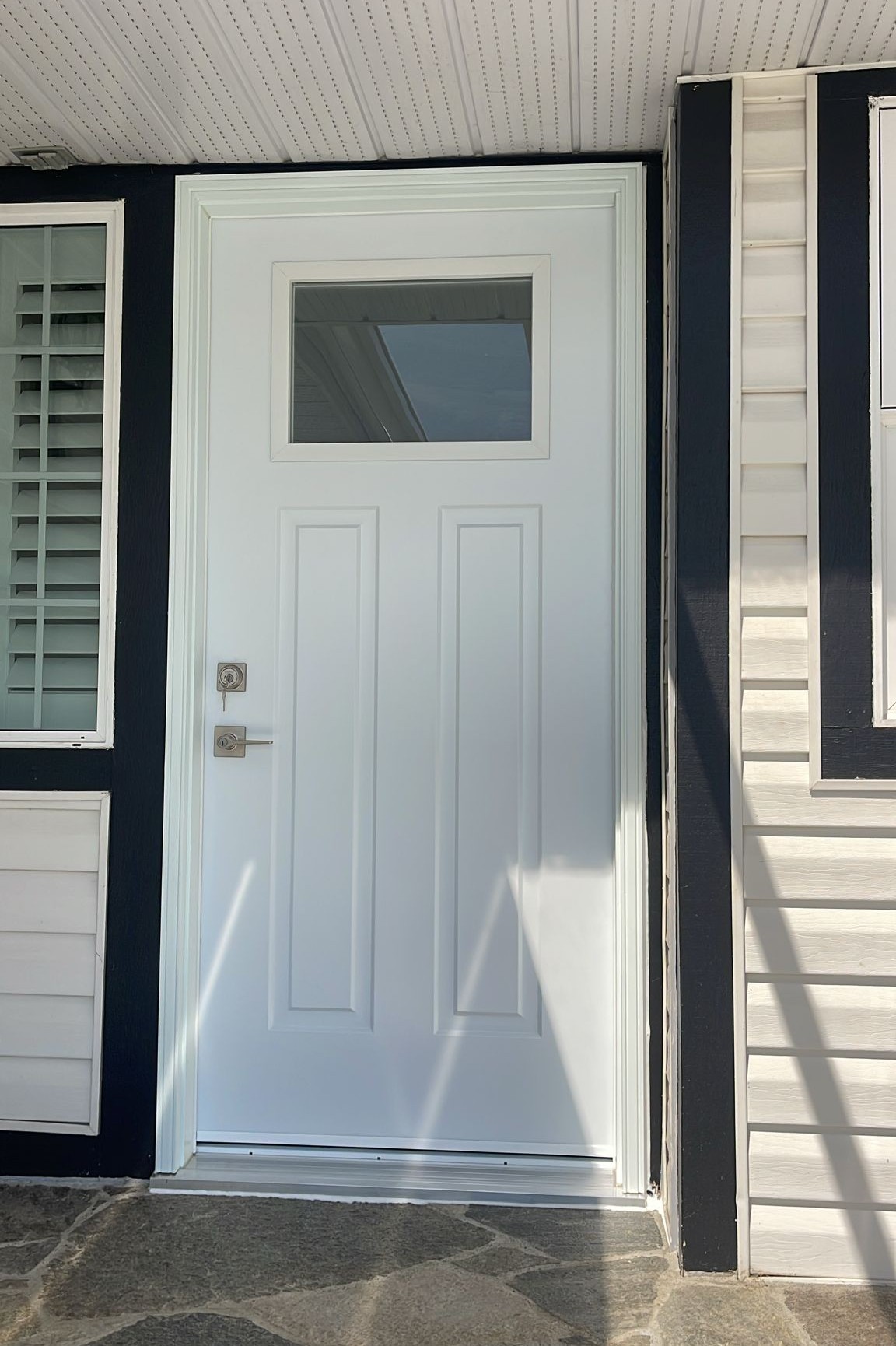 Custom white entry door featuring elegant quarter glass panel in Chilliwack